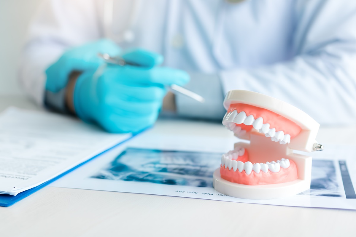 Dentist explaining modern denture treatment options