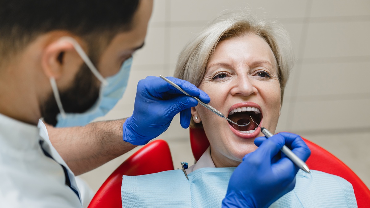 Dentist assessing patient for oral surgery